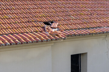 Broken roof tiles showing damage from storm or neglecting maintenance