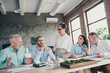 © deagreez - Photo of teamwork people working together senior female boss discuss project comfortable modern office loft room interior indoors workspace