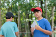 © Sophon_Nawit - Asian schoolboys are studying high level of trees in school botanical garden by using inclinometer and measure tape and looking up for measuring high level of trees and saving information into taplet.