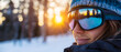 © MonkaLemonka - close-up of a face attractive snowboarder/skier wearing goggles & taking selfie surrouded by white winter scenery; concept of winter sports, hygge, healthy activities on the fresh air