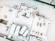 © Anoo - Aerial view of a snowy landscape over a construction site in winter showing covered equipment and materials in a quiet setting
