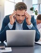 © Marko - Tired businessman, stress or overworked with laptop in anxiety, depression or multitasking at office