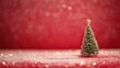© Yilun - A miniature Christmas tree with a star on snow, set against a red background with bokeh lights, ideal for holiday greeting cards, festive banners, seasonal advertisements and digital designs