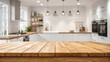 © PETR BABKIN - empty wooden tabletop on kitchen interior background