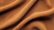 © OMD - Close-up of soft orange fabric with smooth folds and subtle texture, creating an abstract background design.