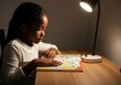 © Anna - Young girl reading a colorful book under a desk lamp in a cozy room at night
