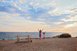 © artmim - Young mother and little daughter walking on the beach in Greece