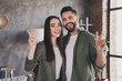 © deagreez - Photo of young attractive charming married people buy flat moving relocation cosy modern loft interior apartment indoors v-sign