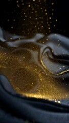 Wall Mural - golden glitter falls onto a dark blue fabric, creating a sparkling effect