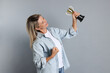 © New Africa - Happy winner with golden trophy cup on gray background