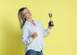 © New Africa - Happy winner with golden trophy cup on yellow background