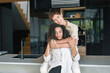 © Dorde - A joyful African American woman and a cheerful Caucasian man share an affectionate embrace, casually dressed, in a modern kitchen setting.