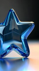 Wall Mural - a blue glass star sits on a table with light reflecting off its surface