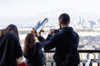 © Kassandra - A girl with her parents on an observation deck looks at the city through a telescope
