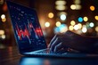 © stockpro - A close-up of a hand typing on a laptop with data visualizations displayed.