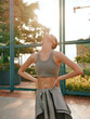 © SHOTPRIME STUDIO - Young woman stretching outdoors in athletic wear, enjoying the sunlight