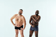 © oneinchpunch - two multiethnic men posing for a male edition body positive beauty set. Shirtless guys with different age, and body wearing boxers underwear
