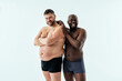 © oneinchpunch - two multiethnic men posing for a male edition body positive beauty set. Shirtless guys with different age, and body wearing boxers underwear