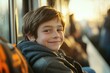 © Alla - A young boy sitting on a train looking directly at the camera