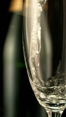 Fototapete - Super Slow Motion of Pouring Champagne Wine on Black Background. Filmed on High Speed Cinema Camera, 1000fps. Vertical Aspect Ratio.