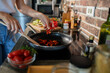 © Geber86 - Young woman cooking healthy vegetables in modern kitchen