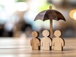 © Tonton54 - wooden figure representing leadership concept. Wooden figures with umbrella representing protection and teamwork.