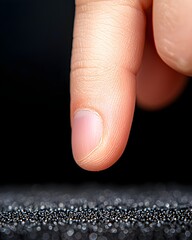 Wall Mural - Close-up of a fingertip touching a textured surface