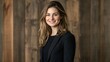 © VisualVortex - Confident Young Businesswoman Smiling in Front of Wooden Wall