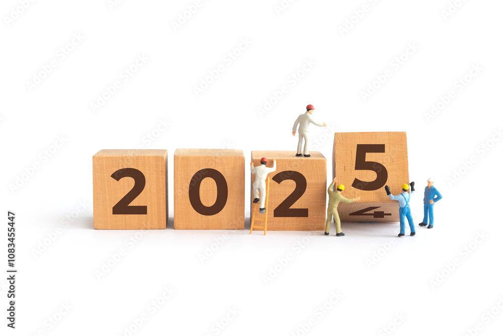 Transitioning from 2024 to 2025 with wooden blocks and miniature people ...