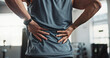 © peopleimages.com - Man, hands and back injury with pain at gym for muscle tension, workout accident or sprain. Closeup, male person or athlete with sore spine, pinch nerve or ache for joint inflammation at health club