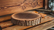 © JamesTeo - A rustic wooden slice, showcasing the intricate grain patterns and weathered bark of a walnut tree, rests atop weathered wooden planks in a carpenter's workshop. Ideal for natural and earthy design pr