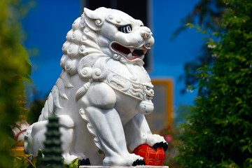 Wall Mural - Cau dung Pagoda.  Guardian. Chinese lion statue represent Yin force, female, negative, take, carry a cub. An Giang Province. Mekong Delta, Vietnam.