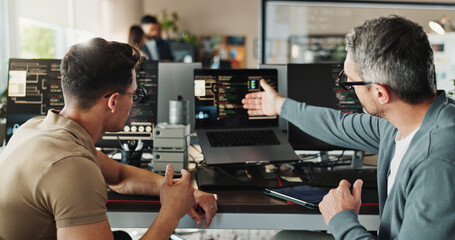 Man, developer and coding teamwork on computer screen in office for testing web application and troubleshooting. Programming, employee or mentor with advice on developing software solution at startup