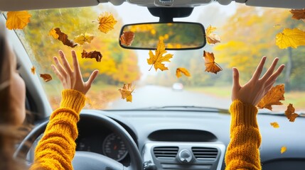 Wall Mural - An excited female tourist was driving alone,  enjoying the freedom of a road trip.   A woman's joy and freedom in autumn shows her love for life and her anticipation  for new adventures.