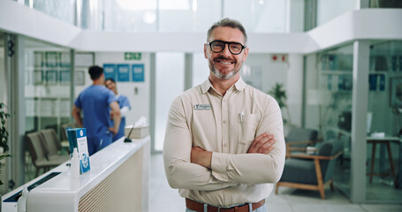 Wall Mural - Doctor, portrait and hospital with chief, arms crossed and manager at clinic with smile. Mature, medical and leader with confidence and pride from healthcare, about us and success with integrity