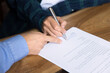 © fizkes - Close up, two unrecognizable businesswomen, customer and sales manager sit at desk, agent and client making commercial deal in moment of signing formal document, conclude agreement, legal transactions