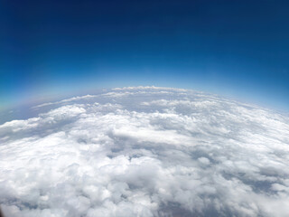 Wall Mural - Curvature of planet earth. Aerial shot. Blue sky and clouds