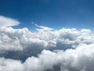 Wall Mural - Blue sky over clouds, View out of an airplane window.