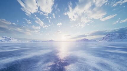 Wall Mural - A serene landscape with snow-covered mountains and a blue sky with white clouds. The sun is setting in the distance, casting a warm glow on the mountains and water.