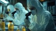 © SHI - Medical workers in protective suits examine laboratory test tubes and medicine bottles under microscopes, focusing on drug research and scientific research.