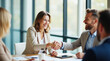 © ProstoSvet - Smiling business professionals shaking hands during a successful meeting in a modern office.