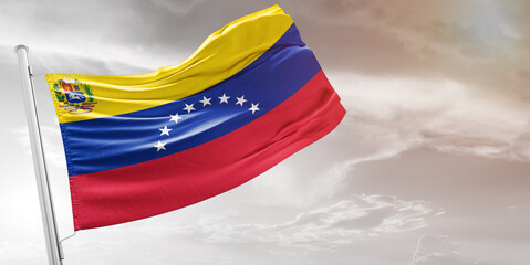 Wall Mural - Venezuela national flag cloth fabric waving on beautiful grey Background.