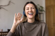 © fizkes - Head shot portrait happy woman wear headphones start videocall talk using application, web cam view face. Videoconference participant enjoy remote conversation by study, personal or business matter