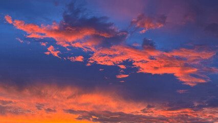 Wall Mural - Fiery Sunset Sky Clouds Glowing Heaven Cloudscape.