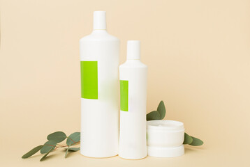 Wall Mural - Shampoo and hair mask with green leaves on color background