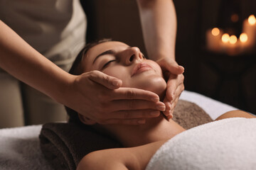 Wall Mural - Attractive woman enjoying face massage, closeup. Beauty procedure