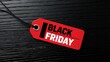 © ANDREY PROFOTO - Black friday sales tag on textured black wooden background