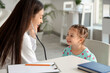 © Pixel-Shot - Female pediatrician with stethoscope listening to cute little girl in clinic