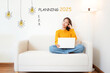 © freebird7977 - 2025 Planning with young woman thinking plan new work.  People cheerful and happy new year with laptop on the sofa in living room.  Star together new year 2025