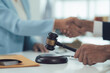 © Kritdanai - Legal Settlement Handshake